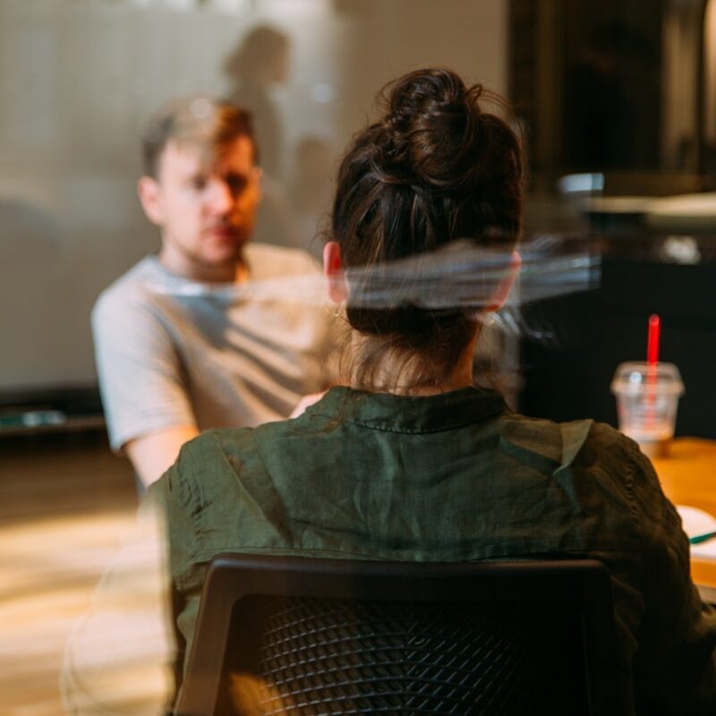 person sitting in a chair in front of a man